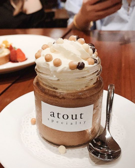 Atout's chocolate pot dessert with whipped cream served in a jar.