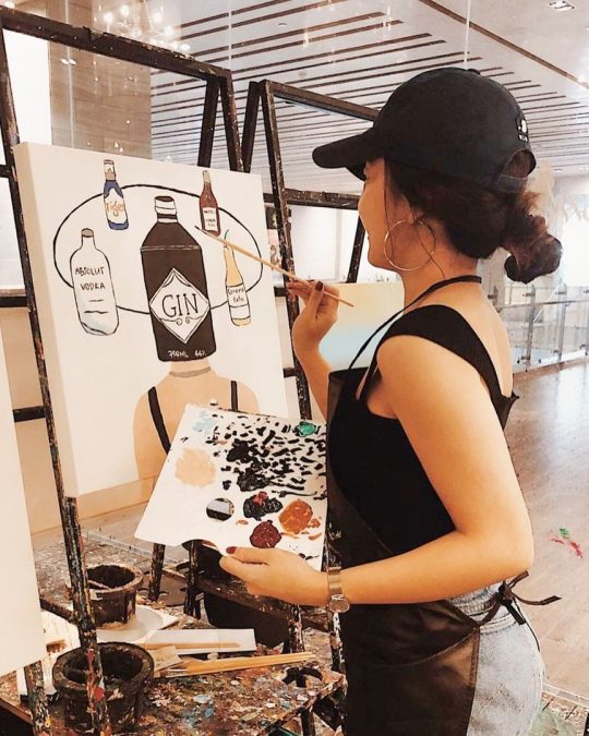a person painting an art piece on a blank canvas