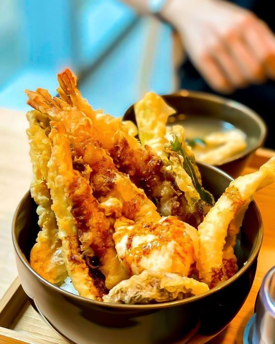 crispy deep-fried seafood and vegetable tempura rice bowl