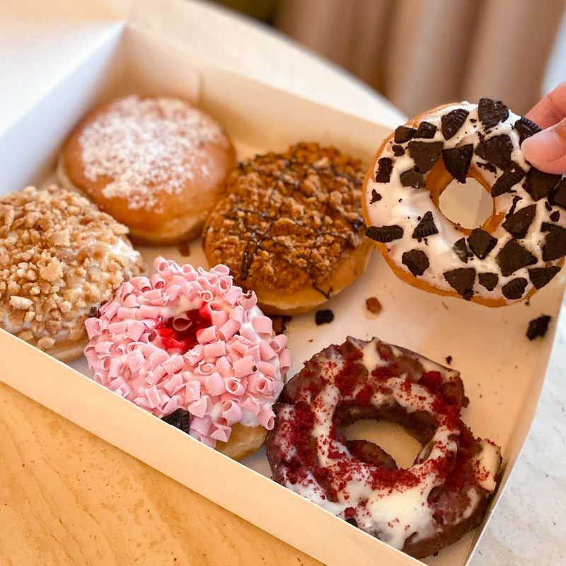 a box of assorted colourful and sweet Krispy Kreme doughnuts
