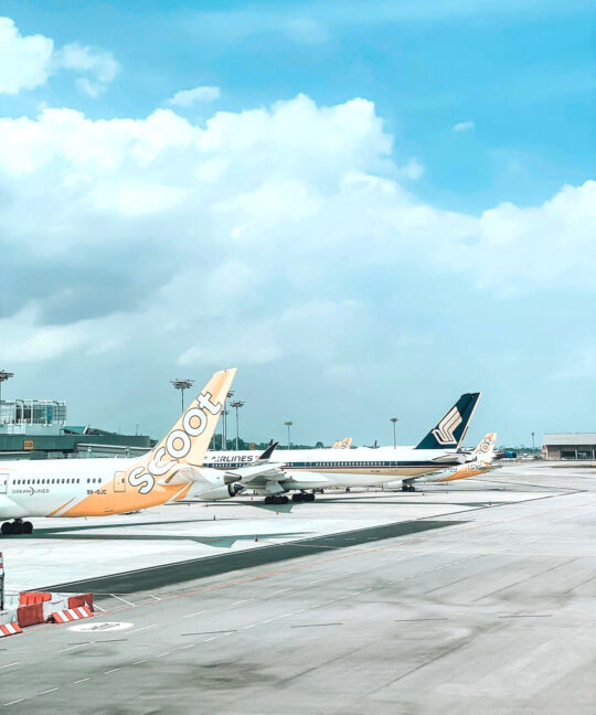 a Singapore Airlines plane, and a Scoot plane at the Apron