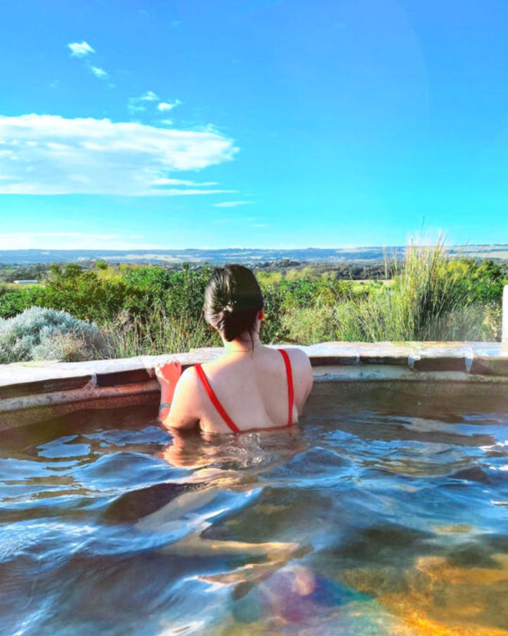 a woman relaxing in a hot spring at Peninsula Hot Springs located at Mornington Peninsula, Australia