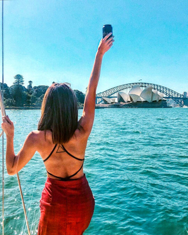 A woman admiring the view of the Sydney Opera House before her