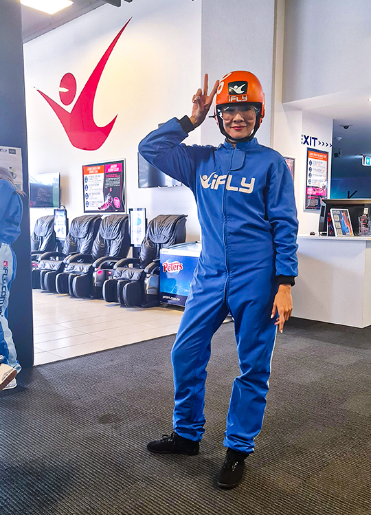 Jade Seah in a blue skydiving jumpsuit with helmet