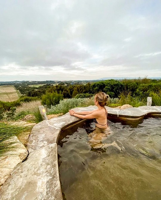 Jade Seah in a Hilltop Pool enjoying the serene view of the hilly landscape