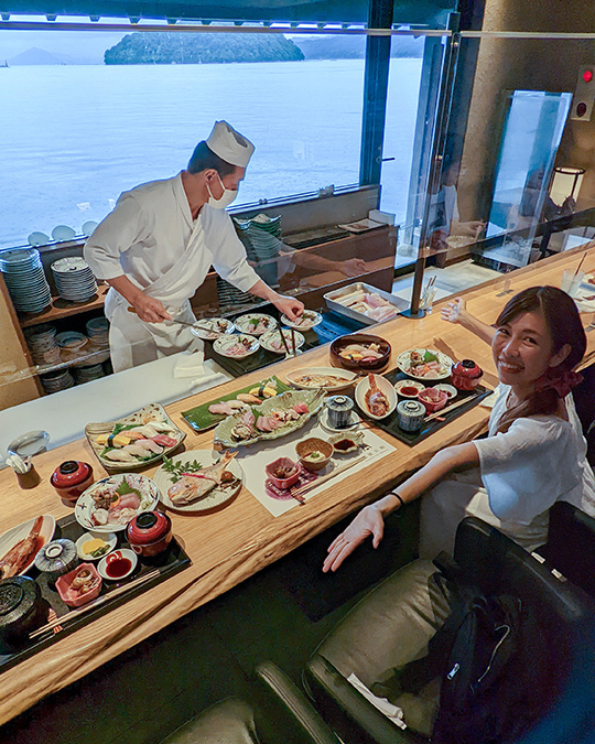 a girl enjoying a meal at Wadatsumi Sushi restaurant