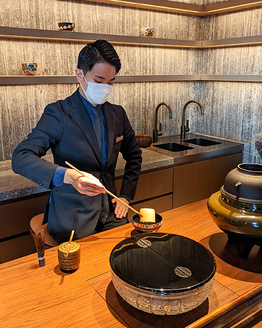 a tea master performing the traditional Japanese tea ceremony at Hotel The Mitsui Kyoto