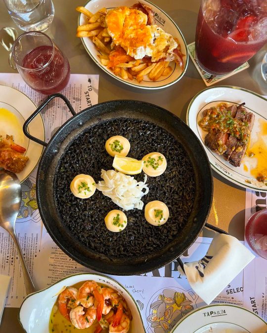squid ink paella with a variety of side dishes
