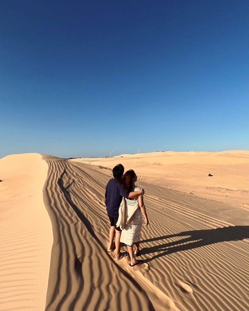 a couple admiring the breathtaking white sand dunes in Mui Ne