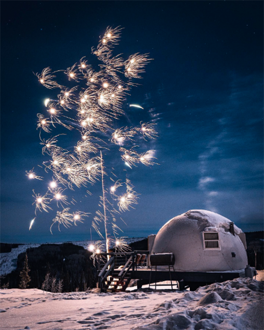 admire the northern lights dancing in the sky  in Alaska's Borealis Base Camp
