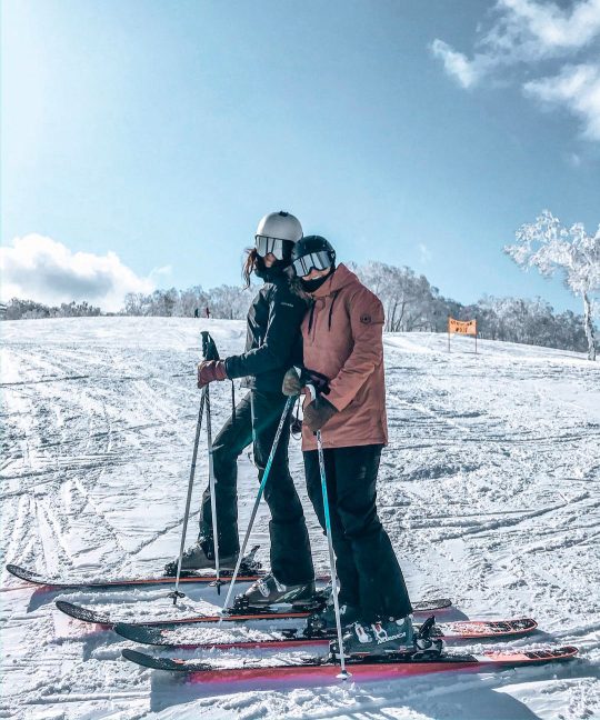 Two people having fun skiing at Niseko
