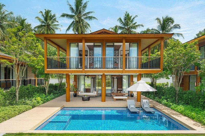 palm trees and a pool at JW Marriott Khao Lak Resort & Spa