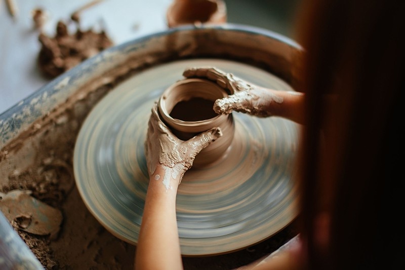 a woman doing pottery